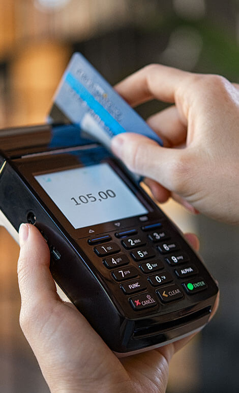 swiping card through payment terminal